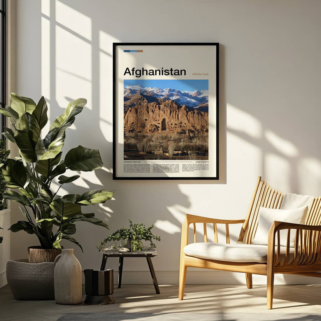Afghanistan Bamiyan Buddha Cliffs Travel Print framed on a pale wall beside houseplants