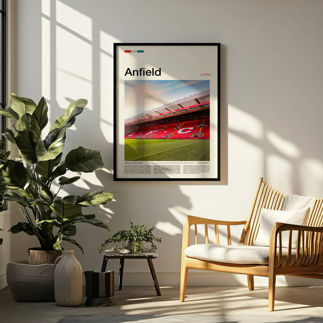 Anfield Stadium Print framed on a pale wall beside houseplants