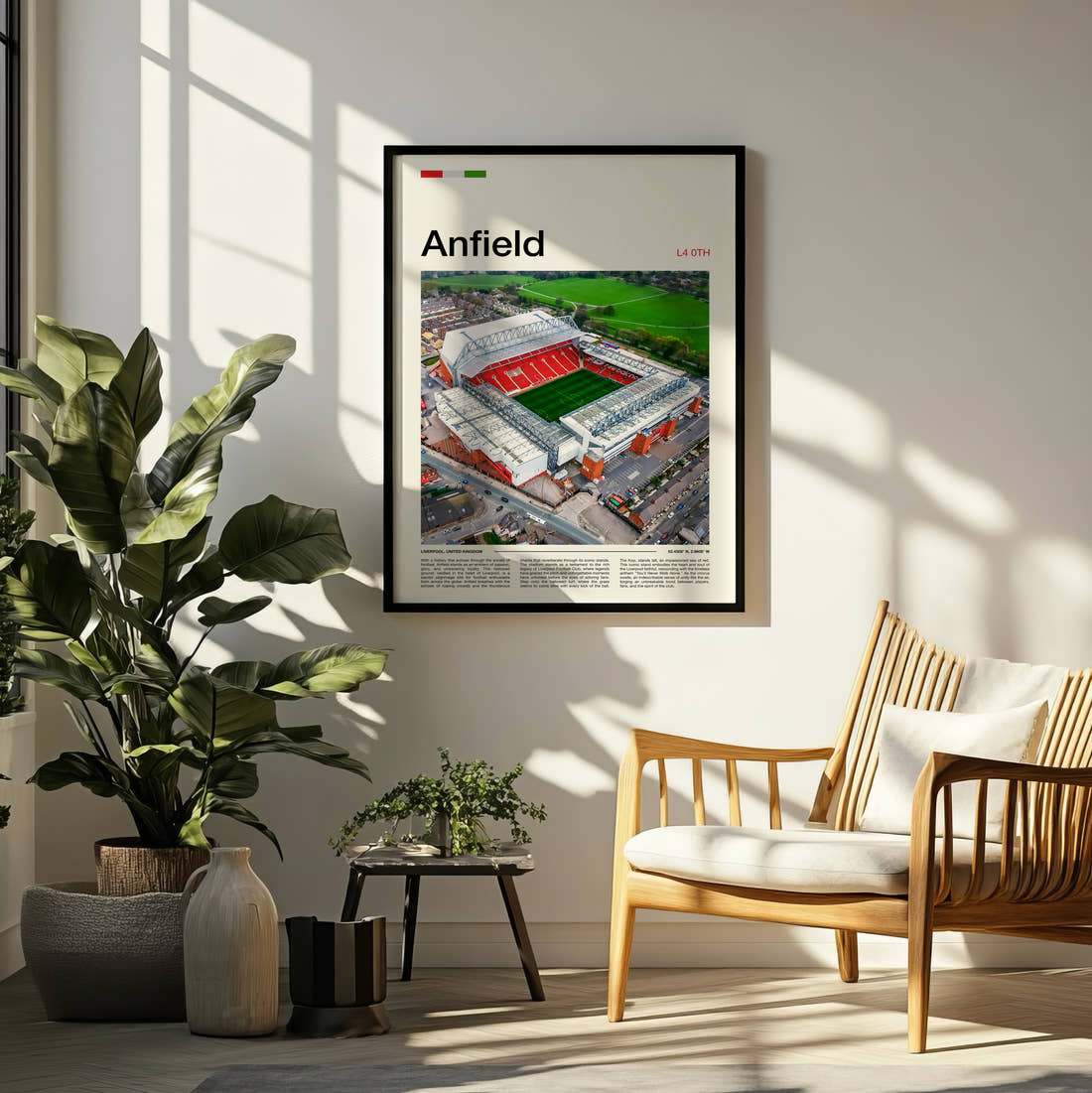 Anfield Stadium Print framed on a pale wall beside houseplants