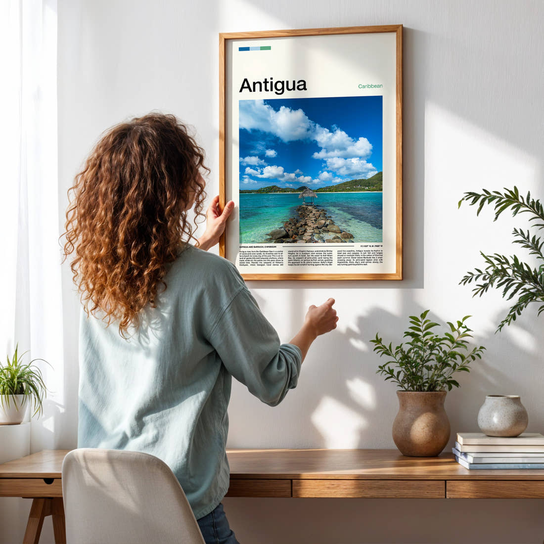 Antigua Stone Jetty Lagoon Travel Print framed on a pale wall beside houseplants