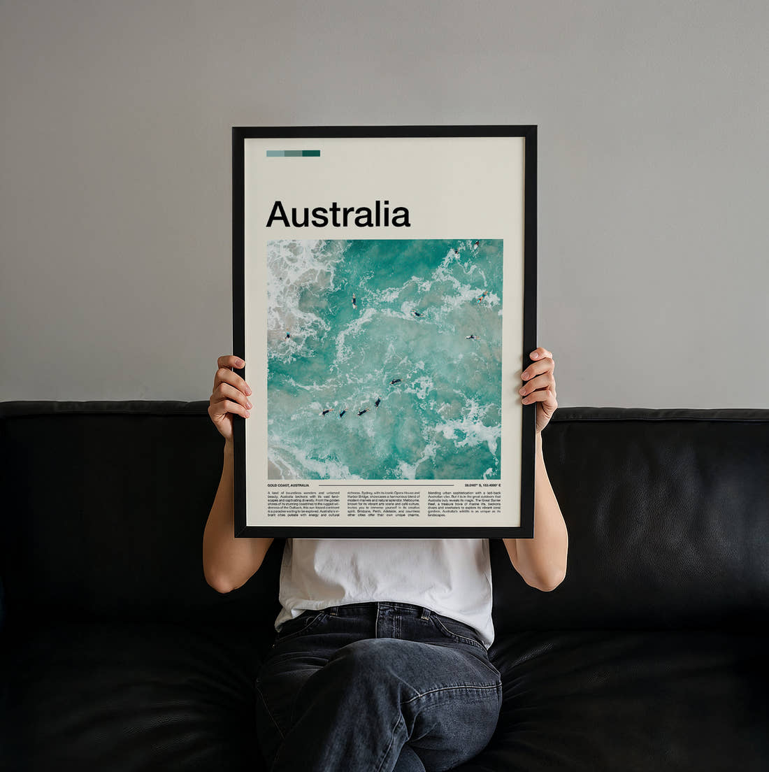 Australia Surfers In The Waves Travel Print held up by hand to show the size of the print