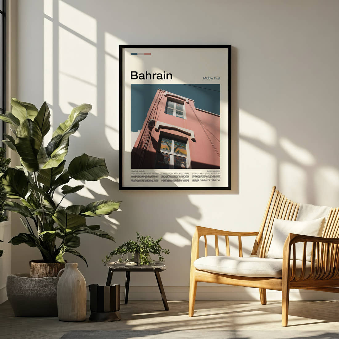 Bahrain Pink Building Facade Travel Print framed on a pale wall beside houseplants
