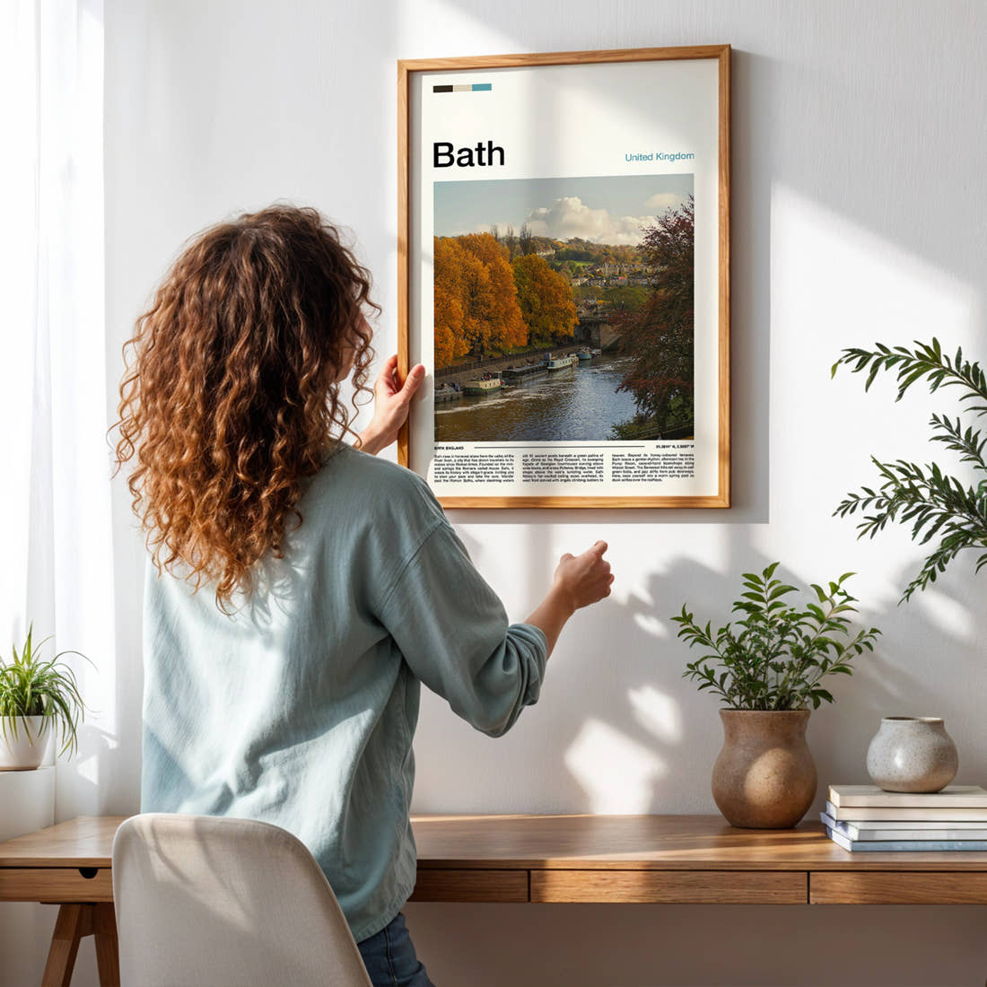 Bath Autumn River View Travel Print framed on a pale wall beside houseplants