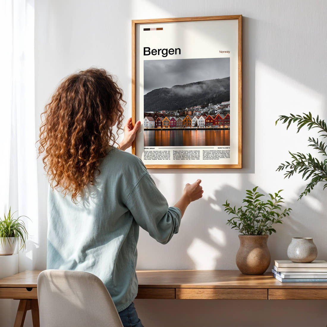 Bergen Bryggen Harbour Reflections Travel Print framed on a pale wall beside houseplants