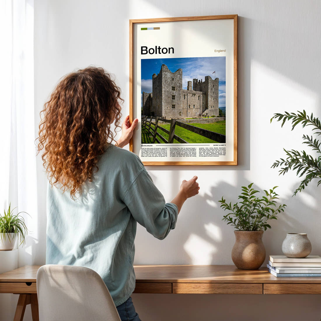 Bolton Stone Castle Facade Travel Print framed on a pale wall beside houseplants