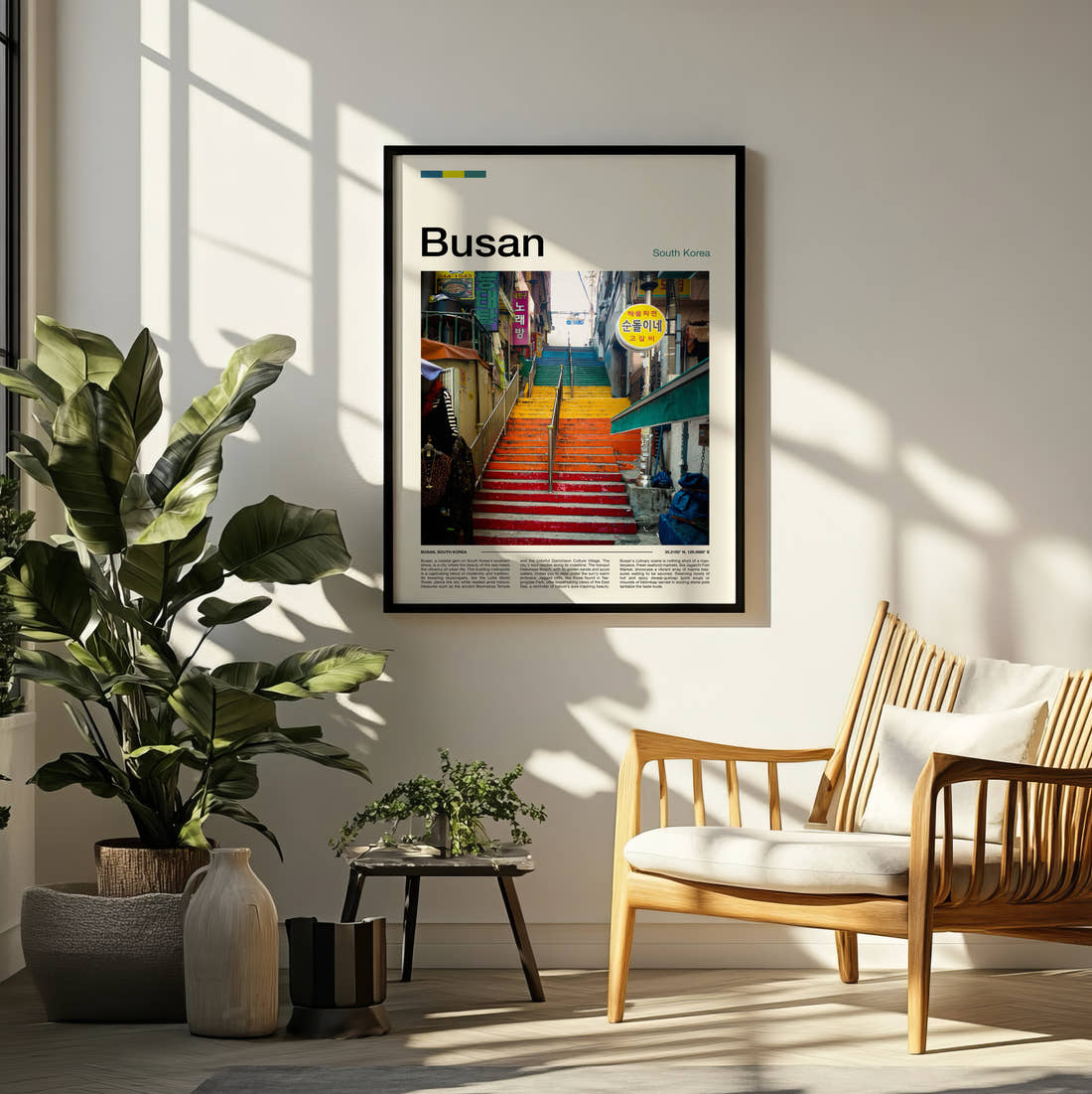 Busan Colourful Painted Steps Travel Print framed on a pale wall beside houseplants
