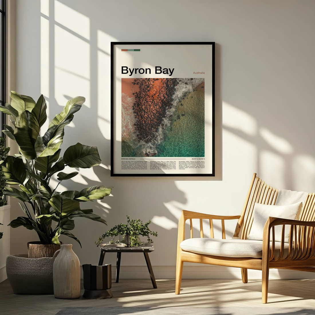 Byron Bay Rocky Reef From Above Travel Print framed on a pale wall beside houseplants