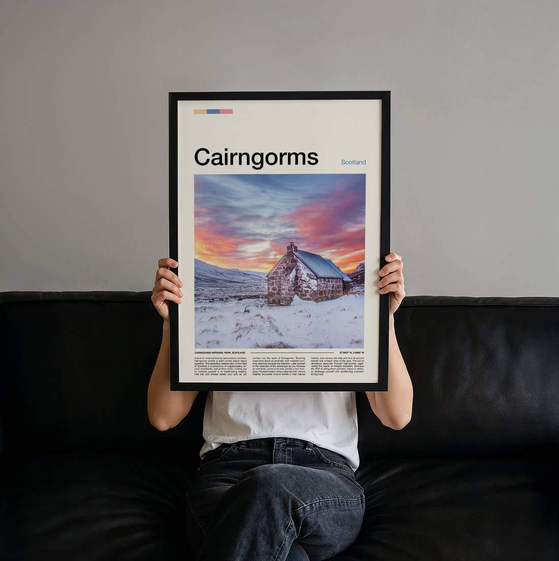 Cairngorms Cottage In The Snow Travel Print held up by hand to show the size of the print