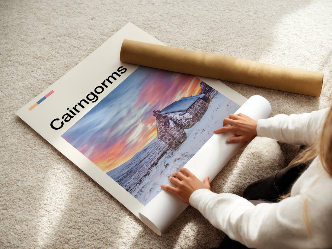 Cairngorms Cottage In The Snow Travel Print being unrolled from its postal tube
