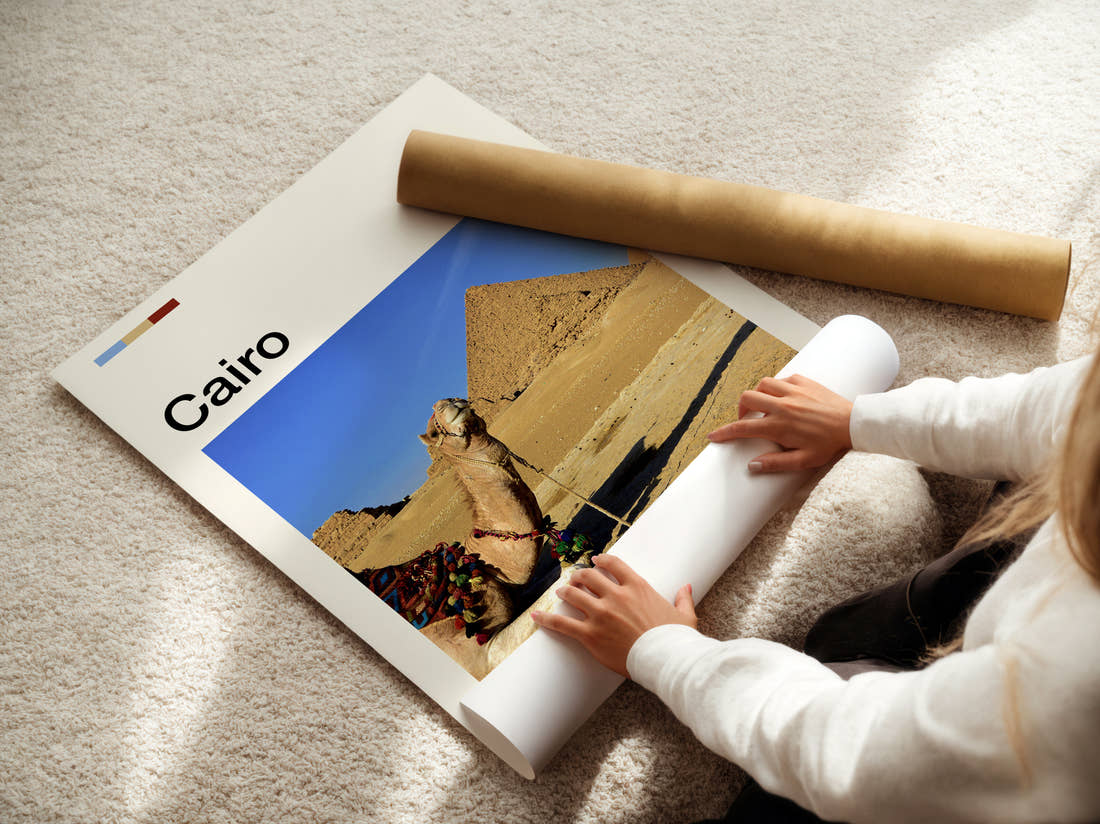 Cairo Camels And Pyramids Travel Print being unrolled from its postal tube