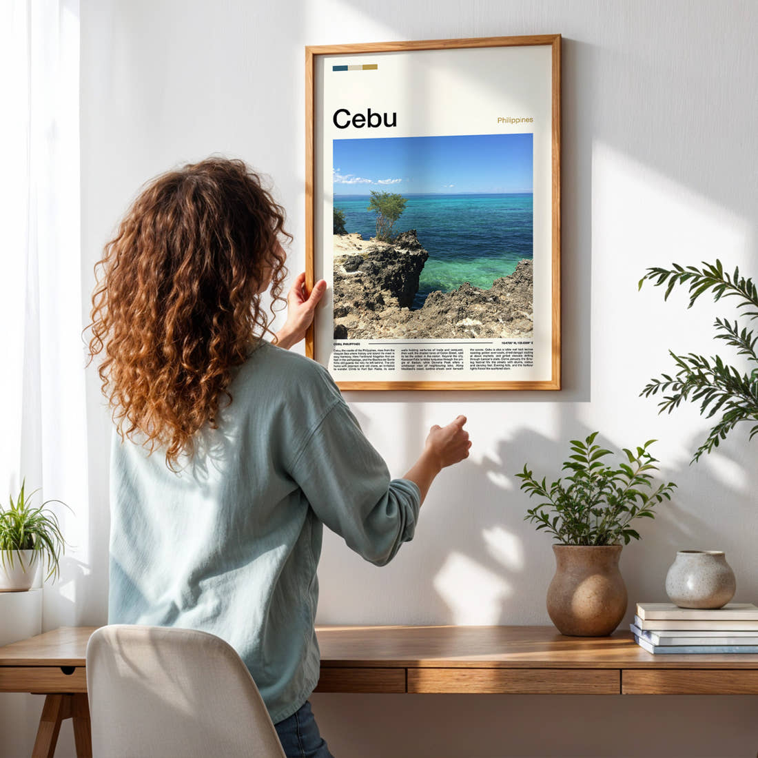 Cebu Rocky Coastal Cliff Travel Print framed on a pale wall beside houseplants