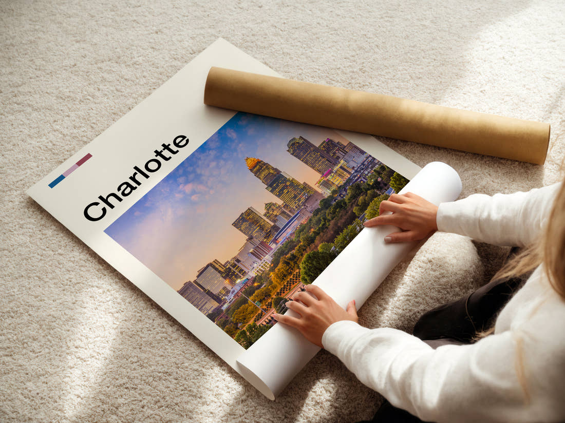 Charlotte Skyline At Dusk Travel Print being unrolled from its postal tube