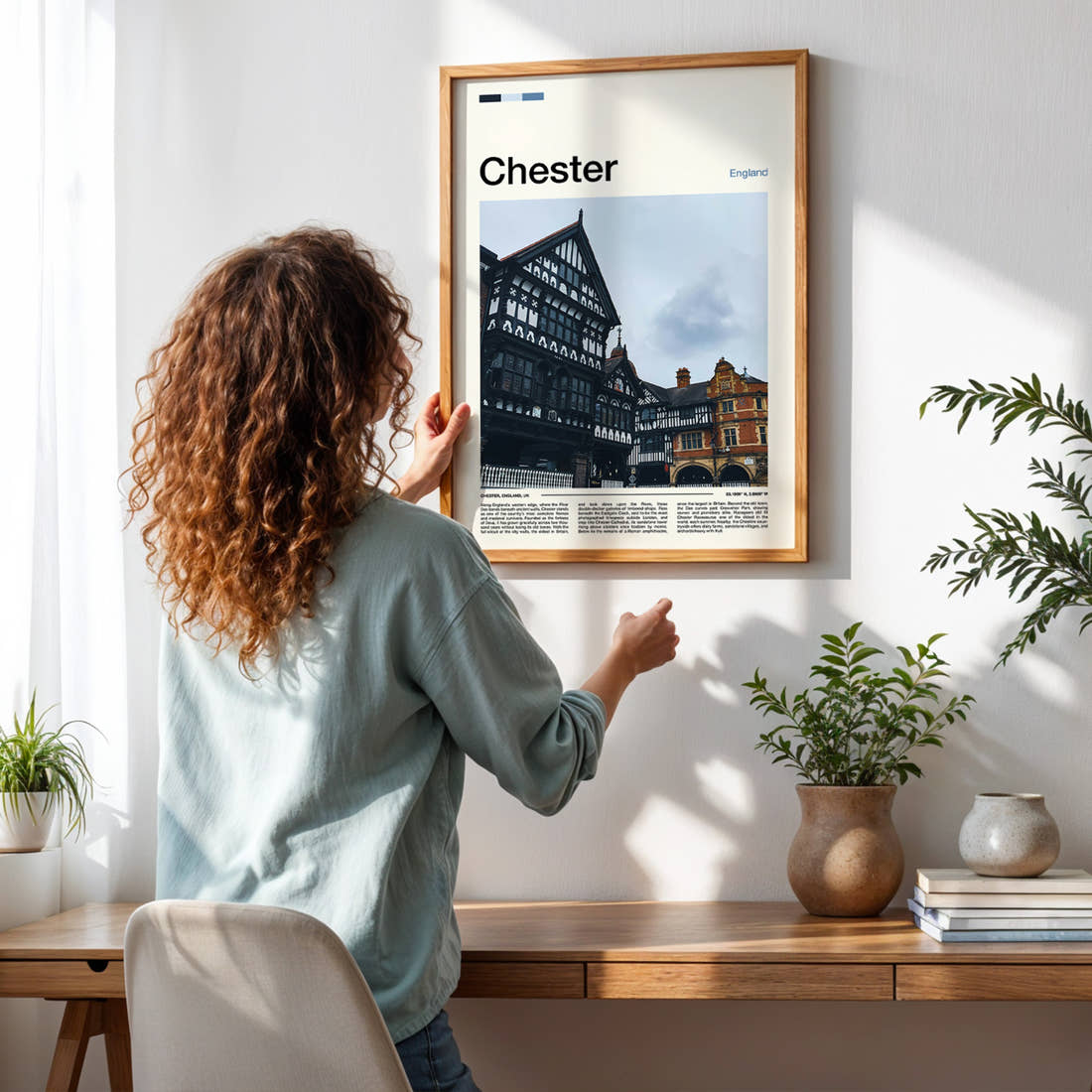 Chester Tudor Timber Rows Travel Print framed on a pale wall beside houseplants