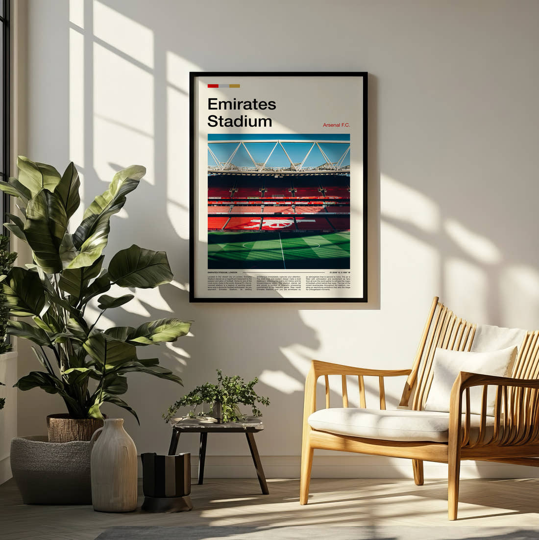 Emirates Stadium Print framed on a pale wall beside houseplants