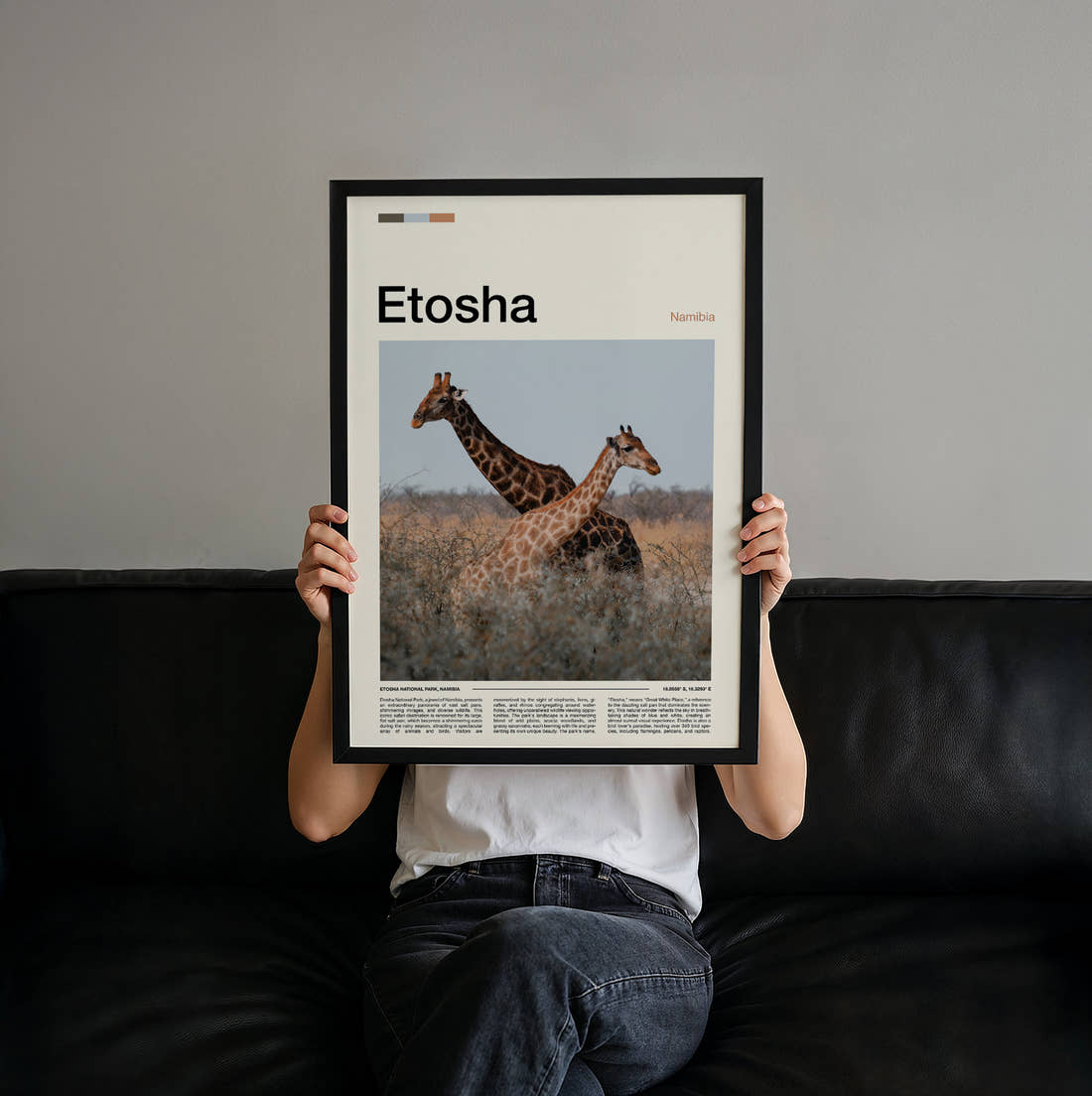 Etosha Giraffes In The Grassland Travel Print held up by hand to show the size of the print