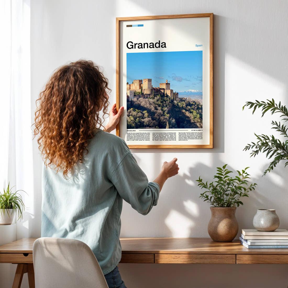 Granada Alhambra Fortress View Travel Print framed on a pale wall beside houseplants