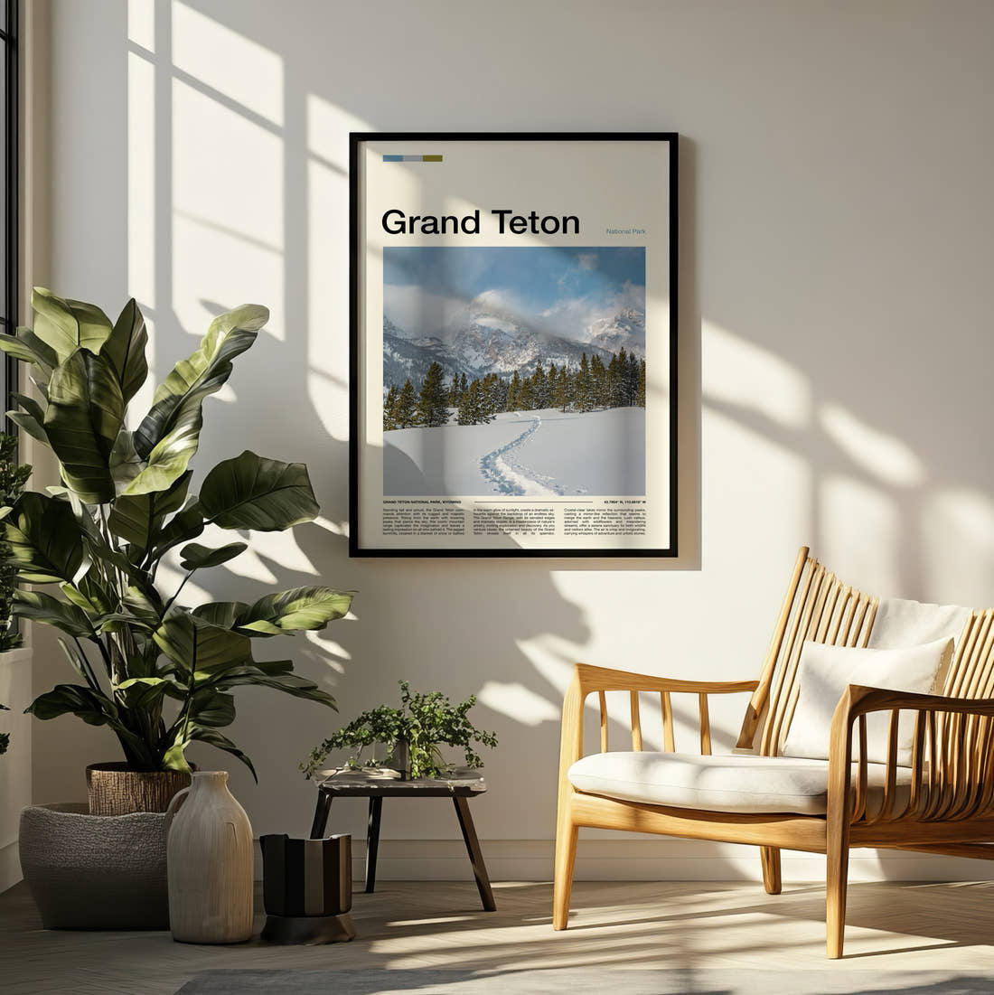 Grand Teton Snowy Trail And Peaks Travel Print framed on a pale wall beside houseplants