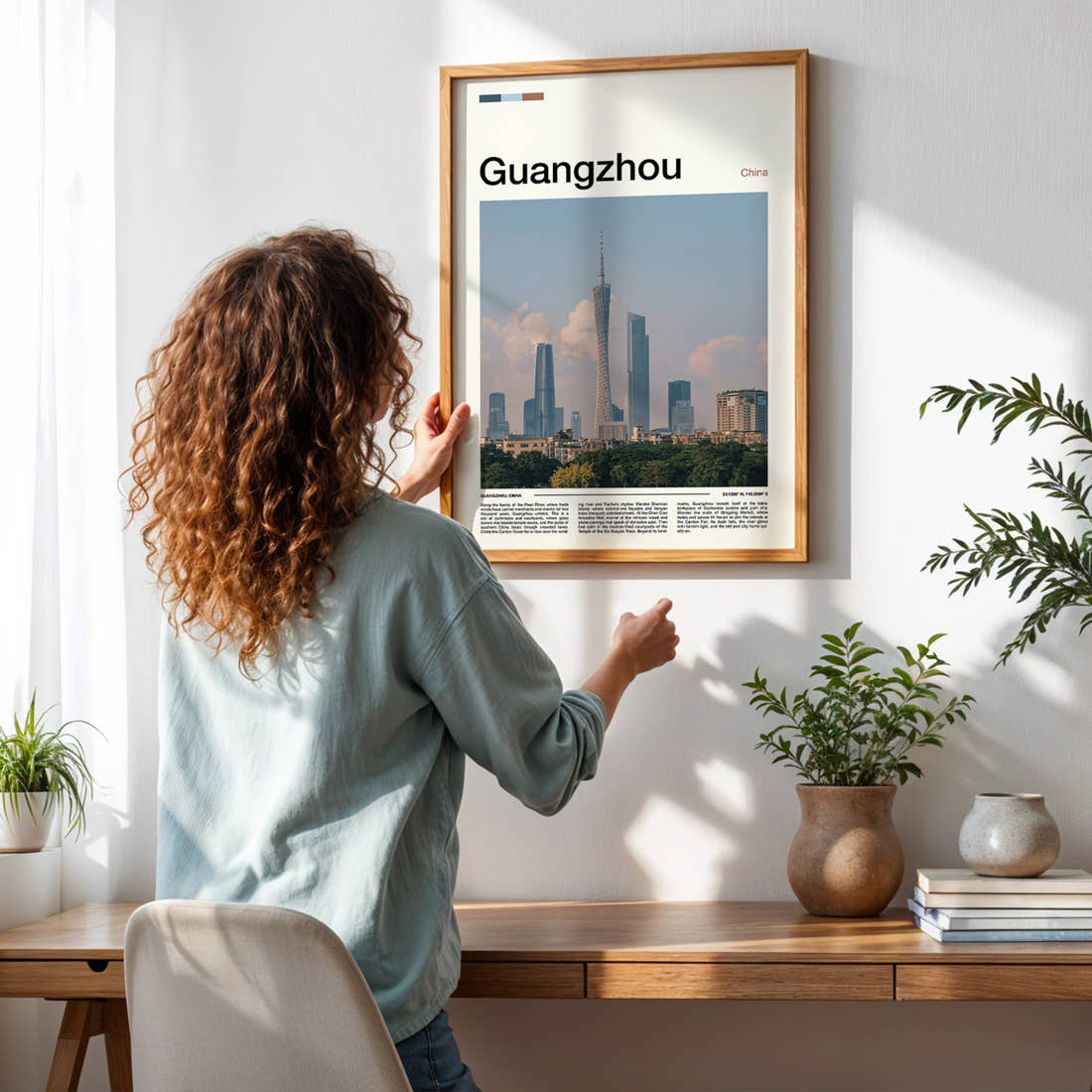 Guangzhou Canton Tower Skyline Travel Print framed on a pale wall beside houseplants
