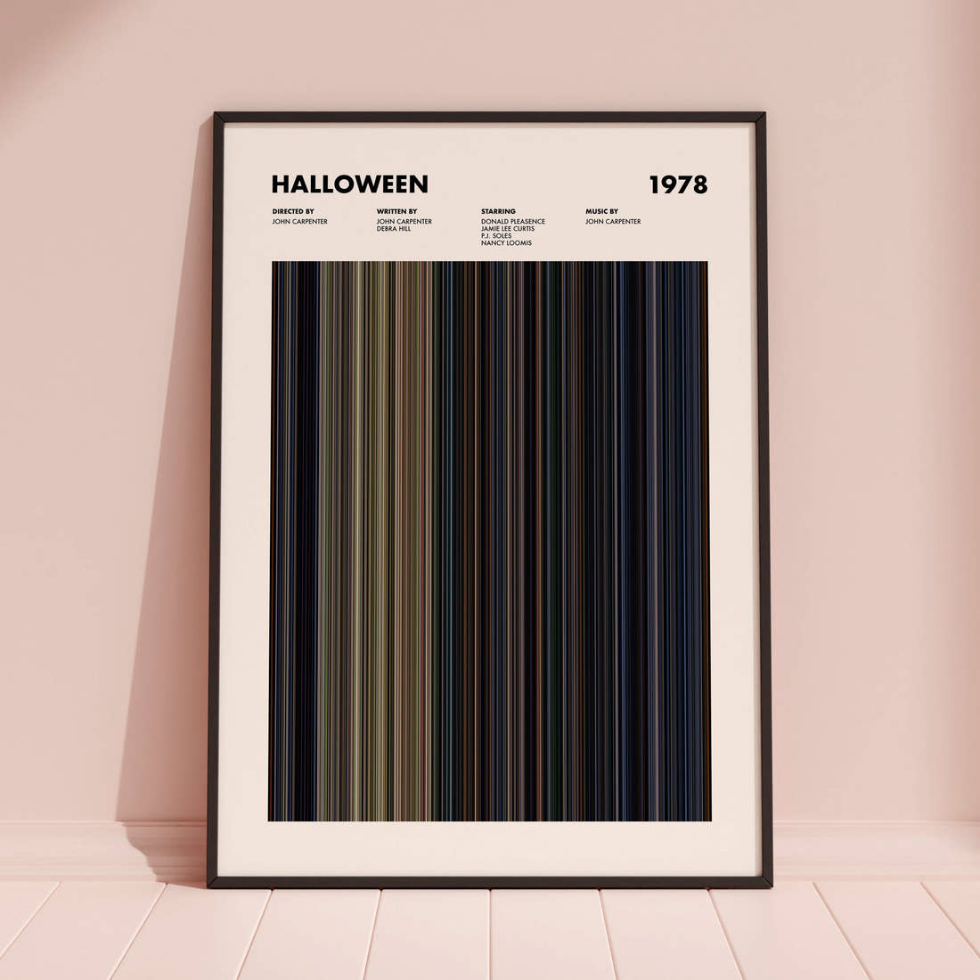 Halloween Movie Barcode Poster framed and leaning against a coloured wall