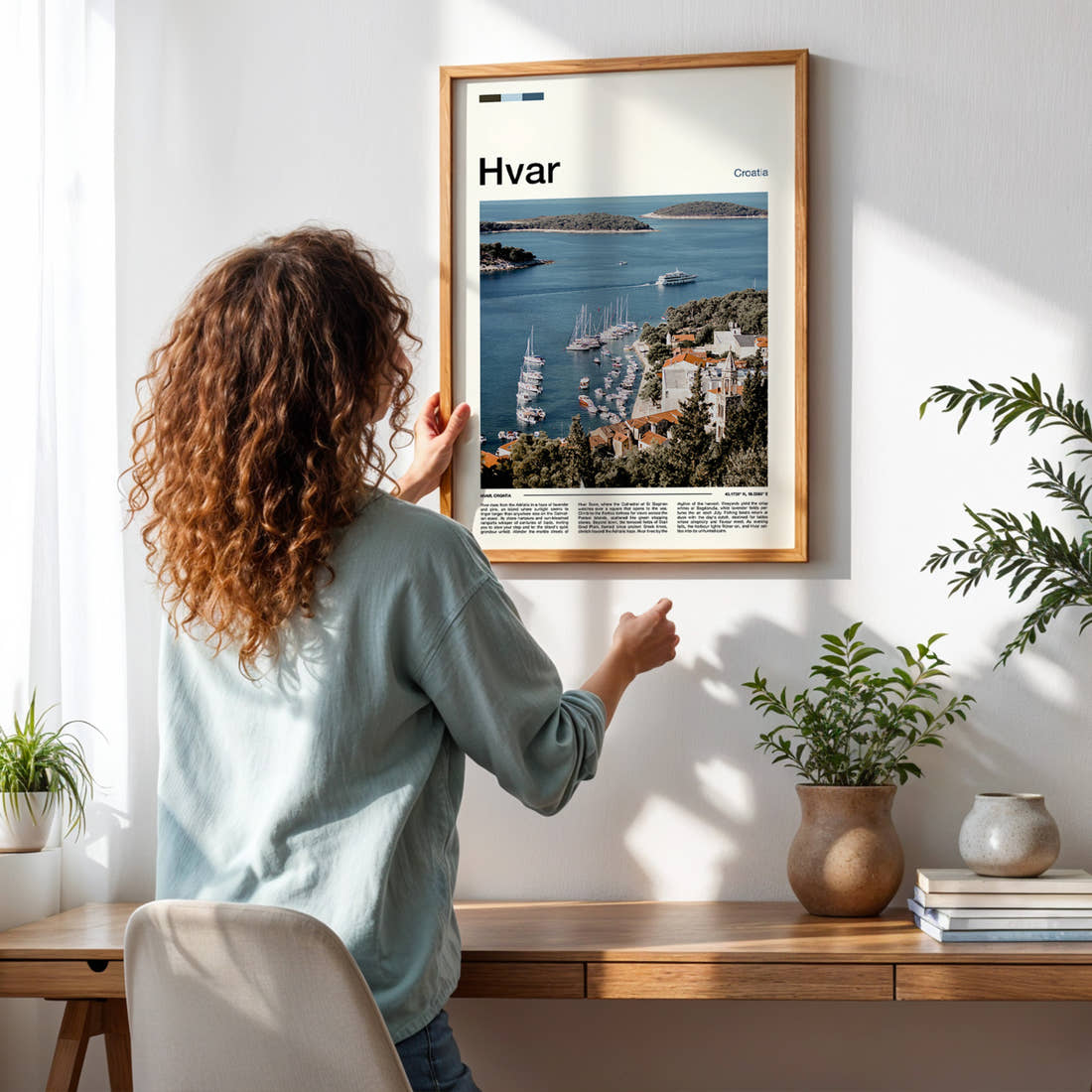 Hvar Harbour From Above Travel Print framed on a pale wall beside houseplants