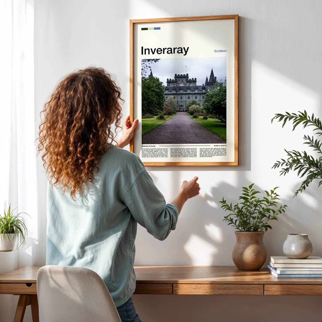 Inveraray Turreted Castle Approach Travel Print framed on a pale wall beside houseplants