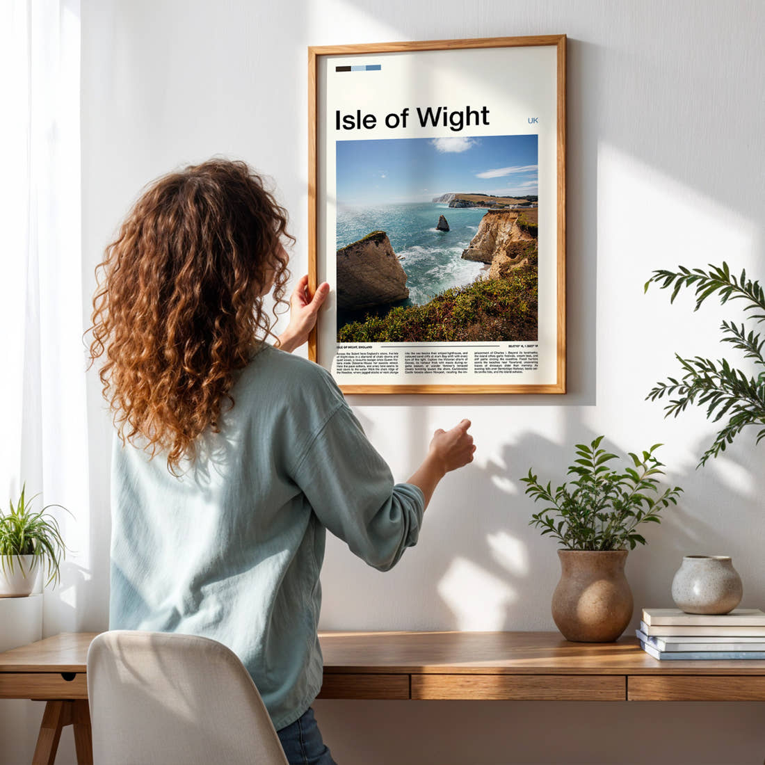 Isle of Wight Chalk Cliffs And Stack Travel Print framed on a pale wall beside houseplants