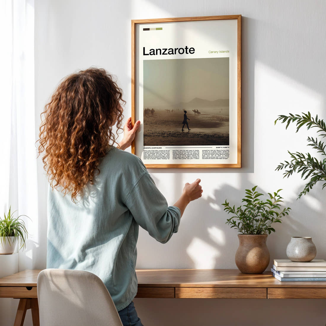 Lanzarote Hazy Coastal Walk Travel Print framed on a pale wall beside houseplants