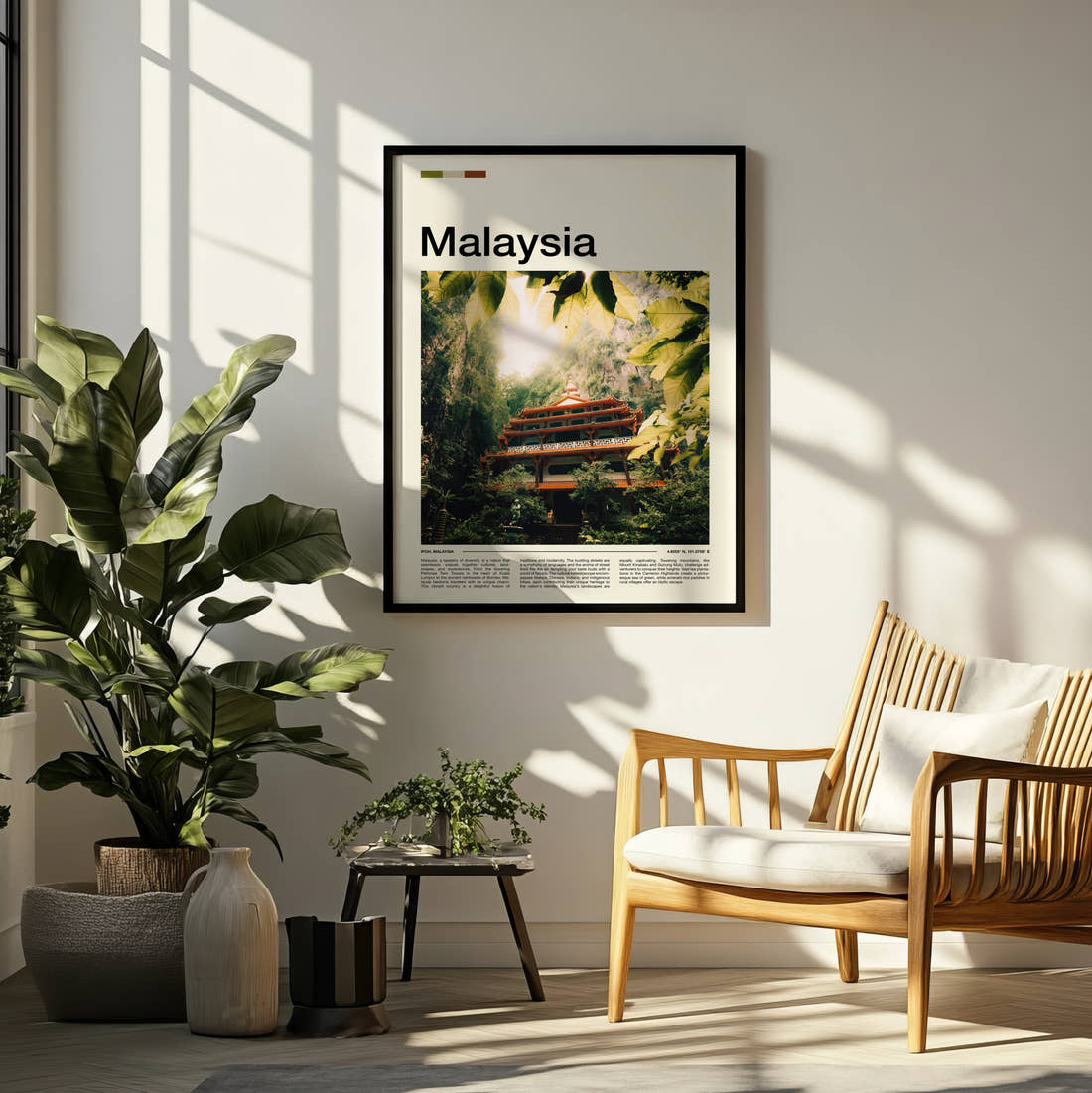 Malaysia Temple In The Jungle Travel Print framed on a pale wall beside houseplants