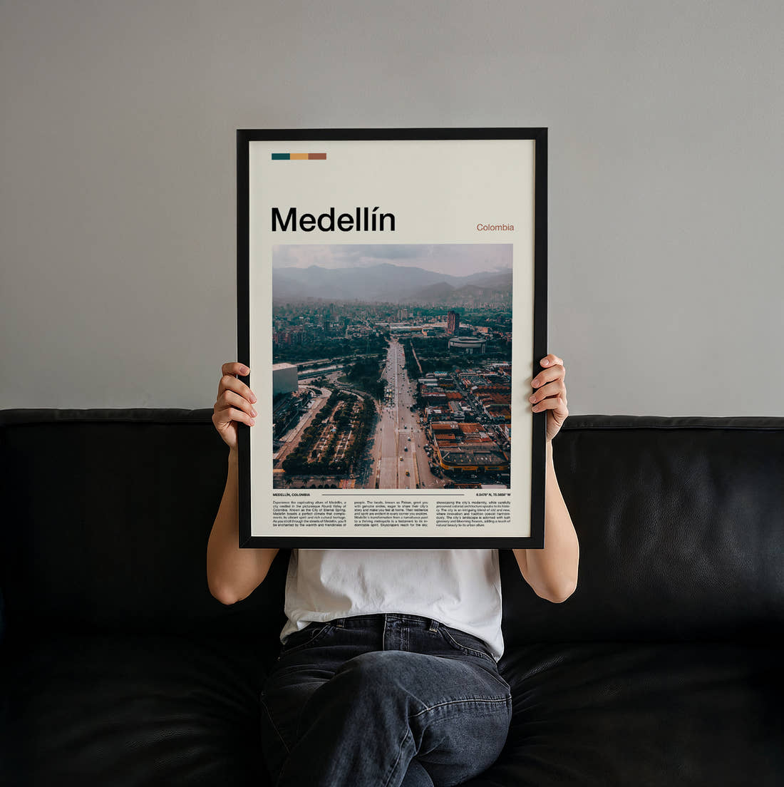 Medellín Avenue Through The City Travel Print held up by hand to show the size of the print