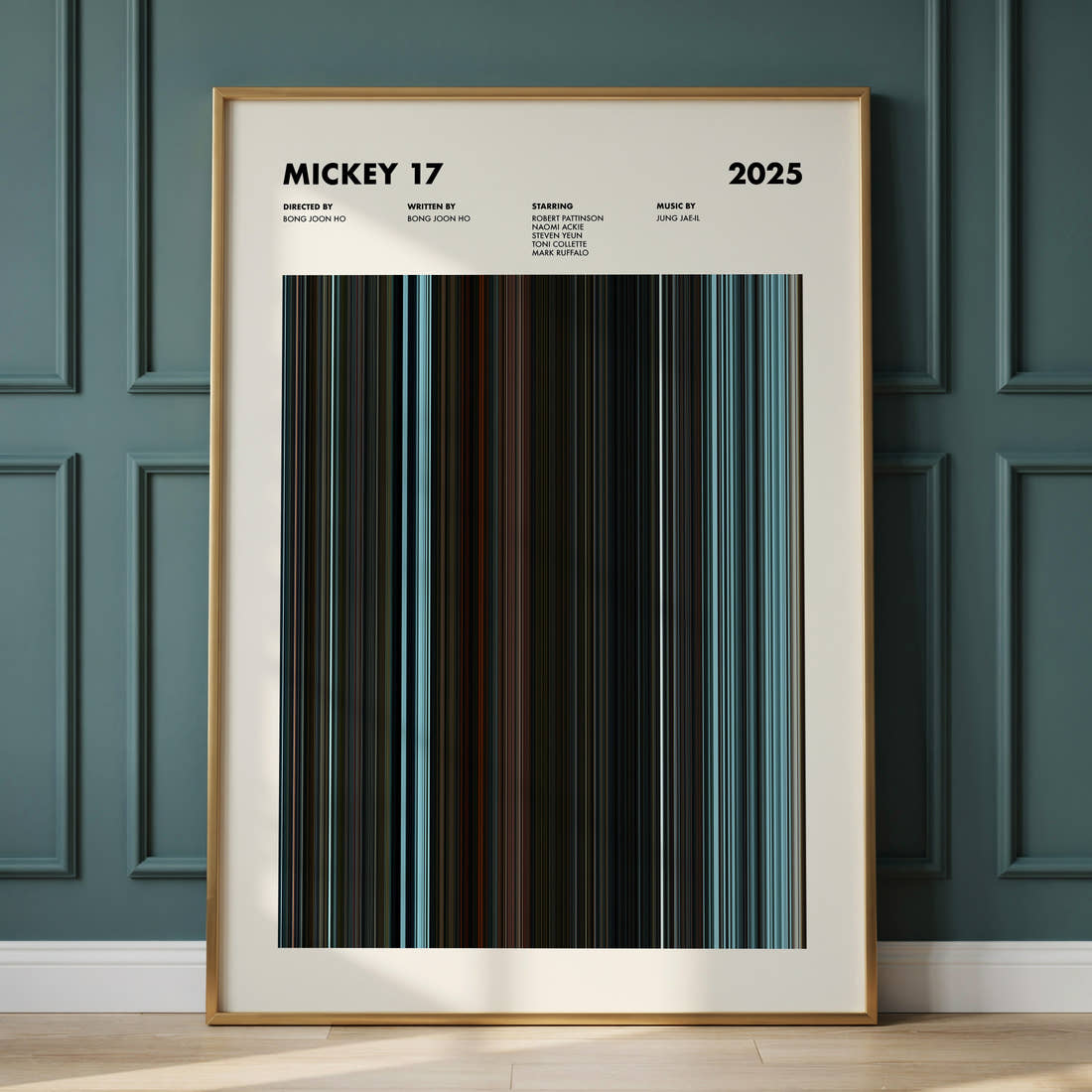 Mickey 17 Movie Barcode Poster framed and leaning against a panelled wall