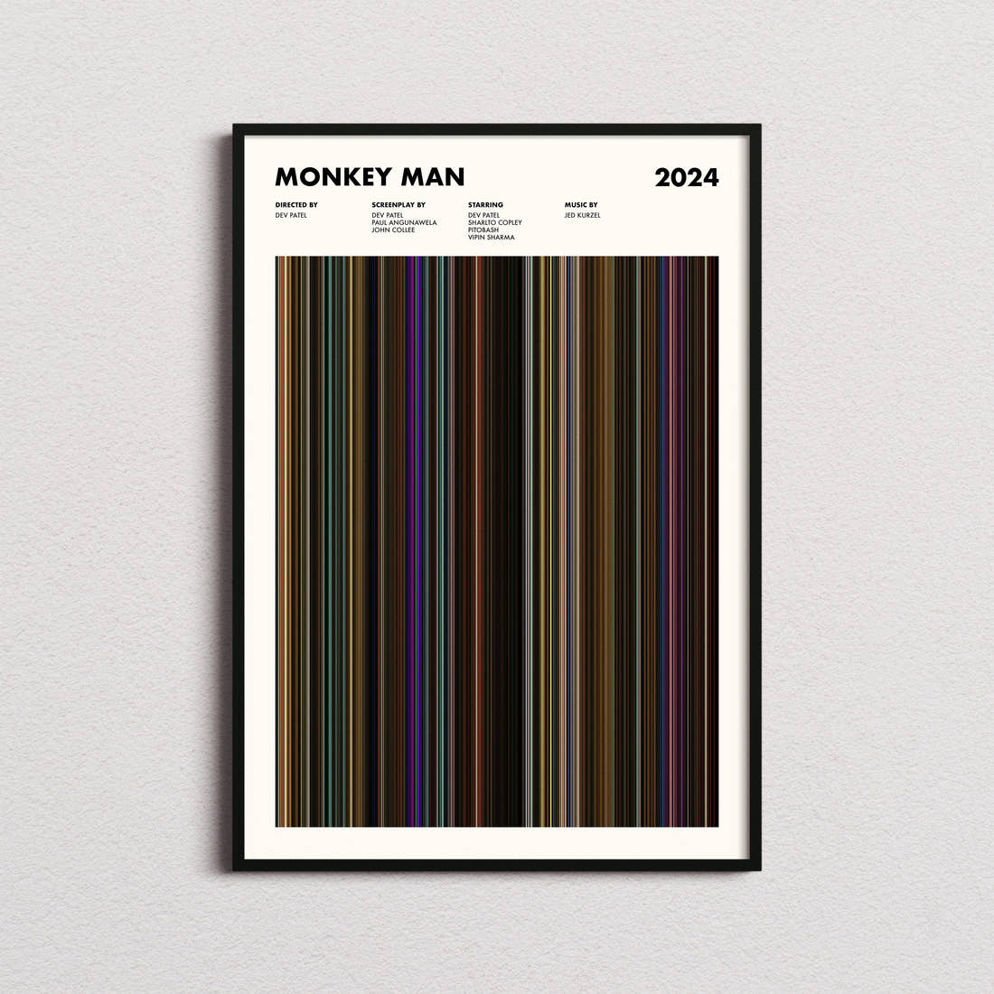 Monkey Man Movie Barcode Poster framed on a plain studio wall