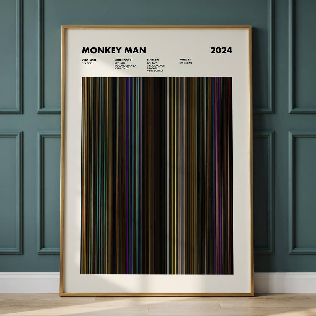 Monkey Man Movie Barcode Poster framed and leaning against a panelled wall