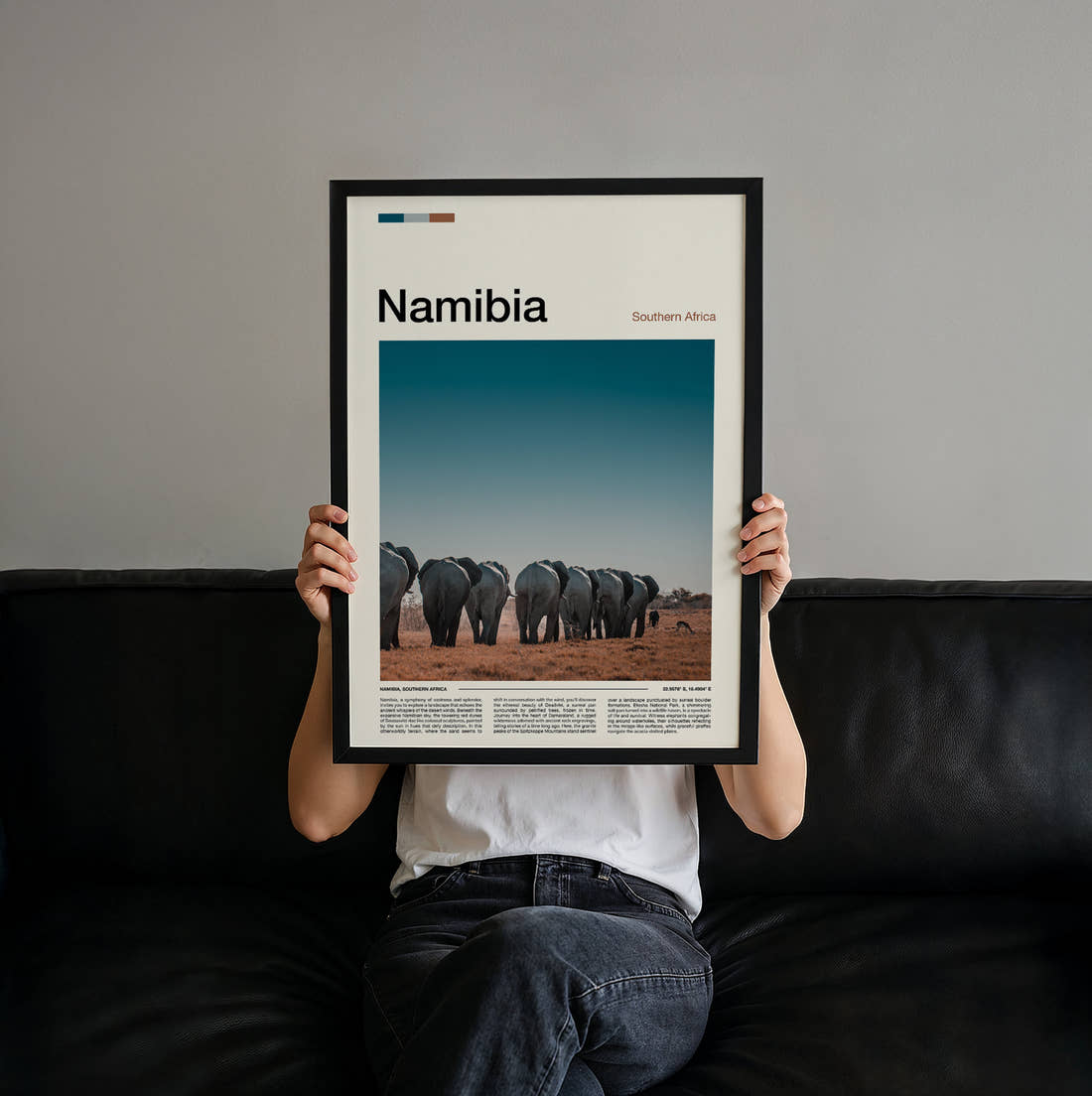 Namibia Herd Of Elephants Travel Print held up by hand to show the size of the print