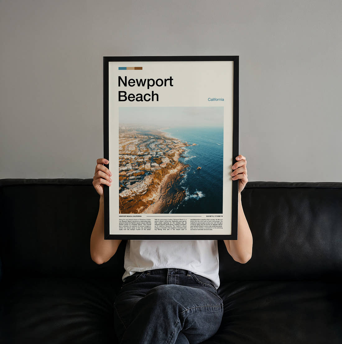 Newport Beach Rocky Coastline Aerial Travel Print held up by hand to show the size of the print