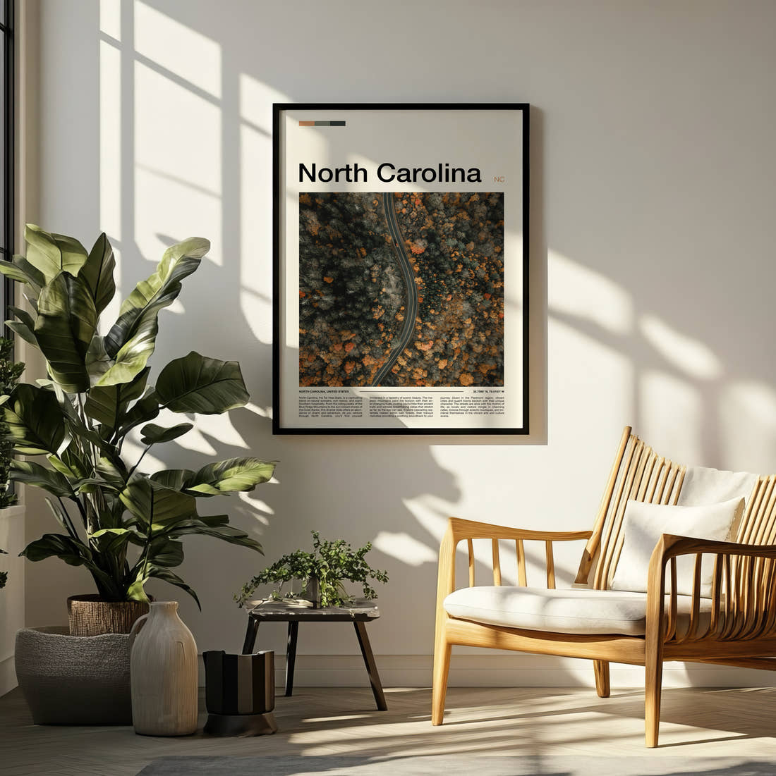 North Carolina Road Through Autumn Forest Travel Print framed on a pale wall beside houseplants