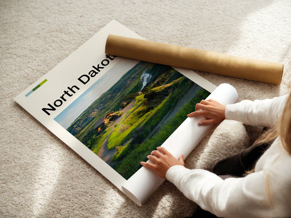 North Dakota Green Hills And River Travel Print being unrolled from its postal tube