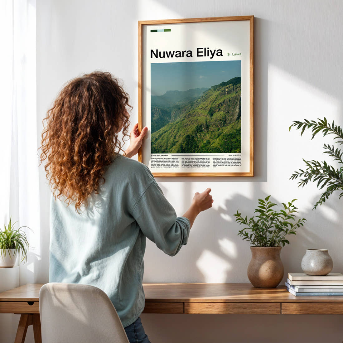Nuwara Eliya Emerald Highland Ridge Travel Print framed on a pale wall beside houseplants