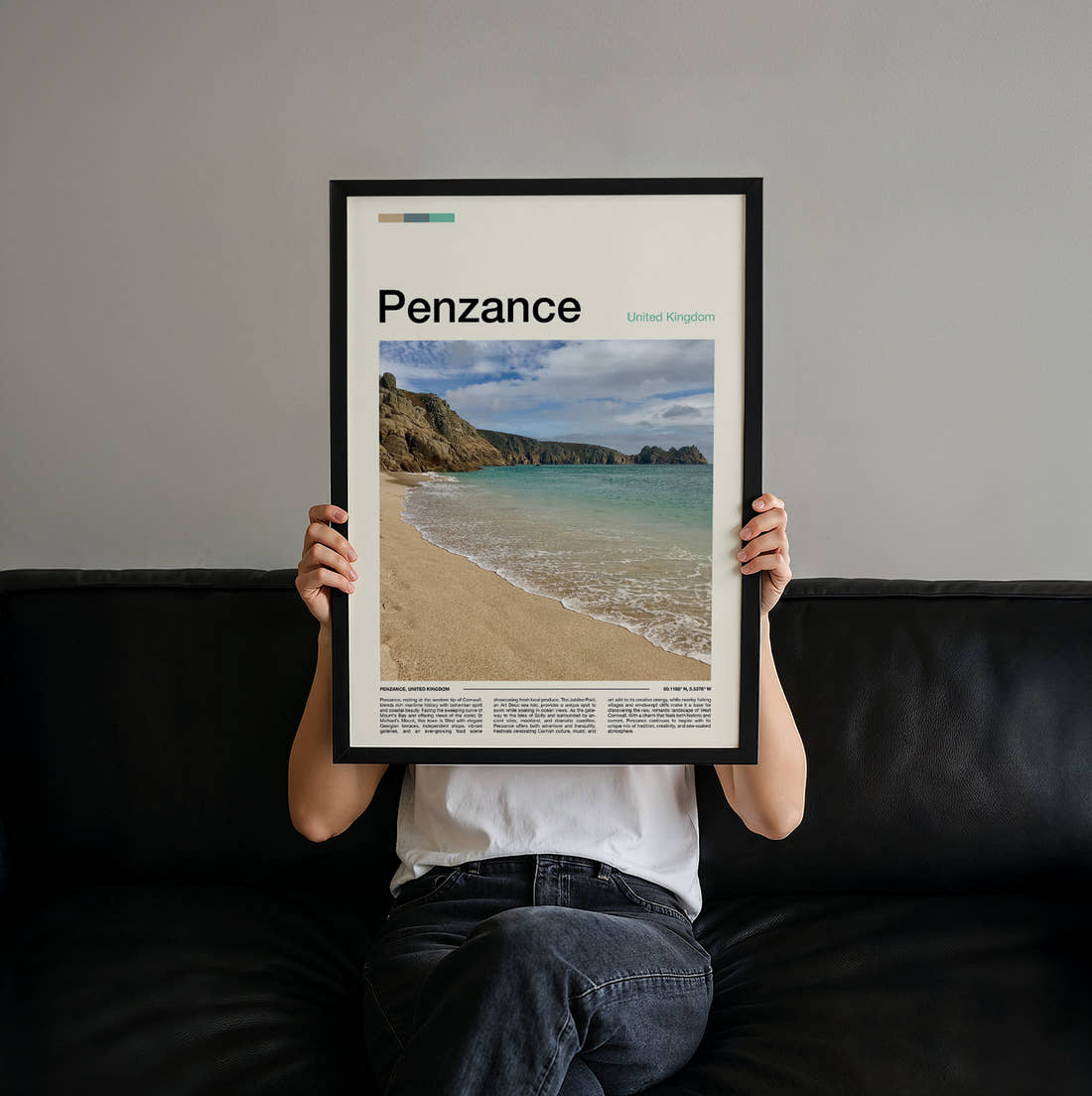 Penzance Beach And Cliffs Travel Print held up by hand to show the size of the print
