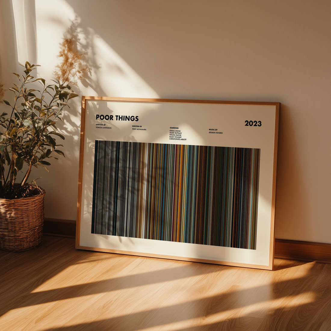 Poor Things Movie Barcode Poster framed and leaning against a wall on a wooden floor