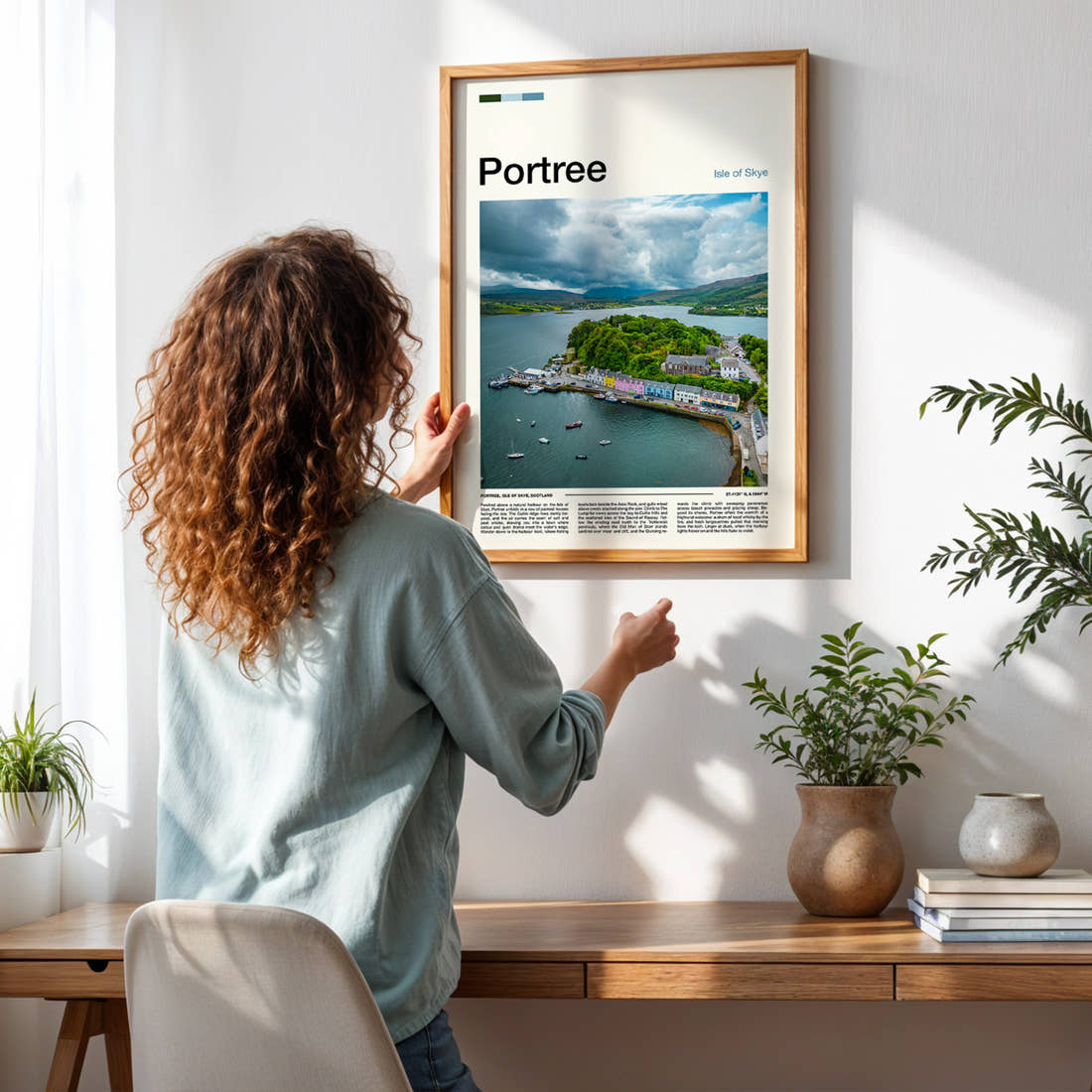 Portree Aerial Harbour View Travel Print framed on a pale wall beside houseplants