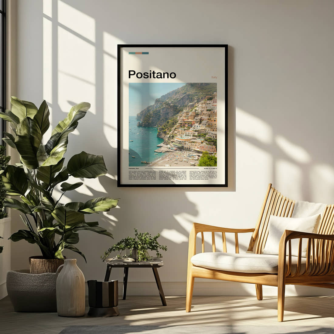 Positano Cliffside Town Travel Print framed on a pale wall beside houseplants