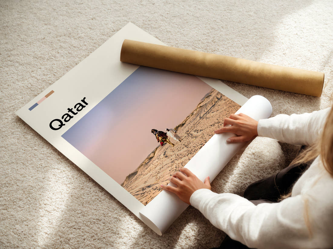 Qatar Camel Rider On Dunes Travel Print being unrolled from its postal tube