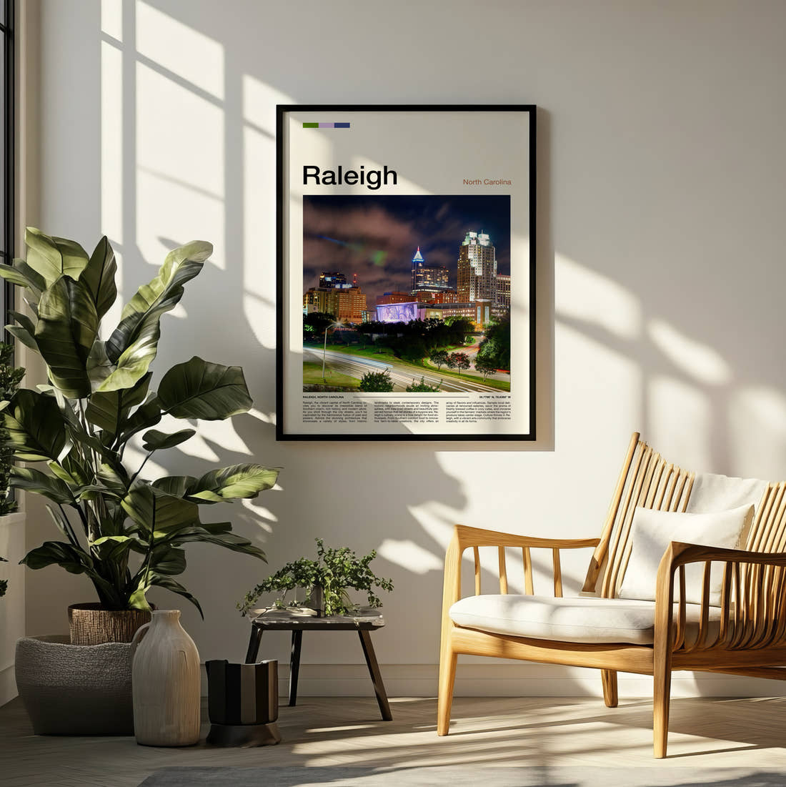 Raleigh Skyline At Night Travel Print framed on a pale wall beside houseplants