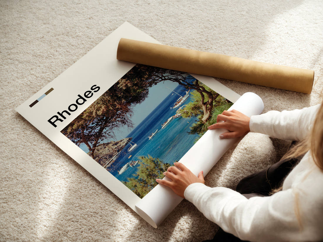 Rhodes Pine-Framed Harbour Bay Travel Print being unrolled from its postal tube