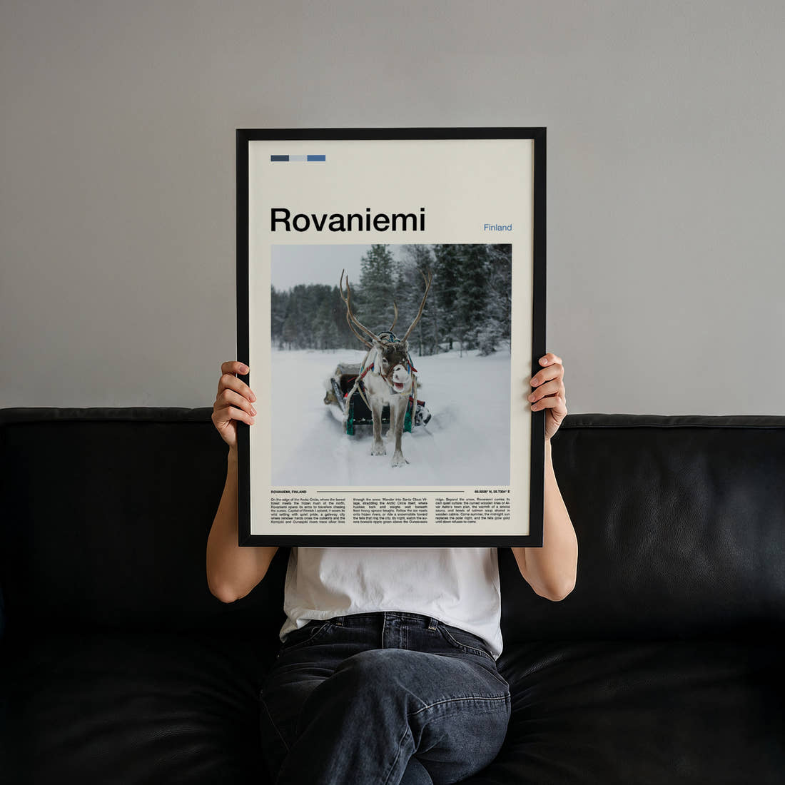 Rovaniemi Reindeer And Sleigh Travel Print held up by hand to show the size of the print