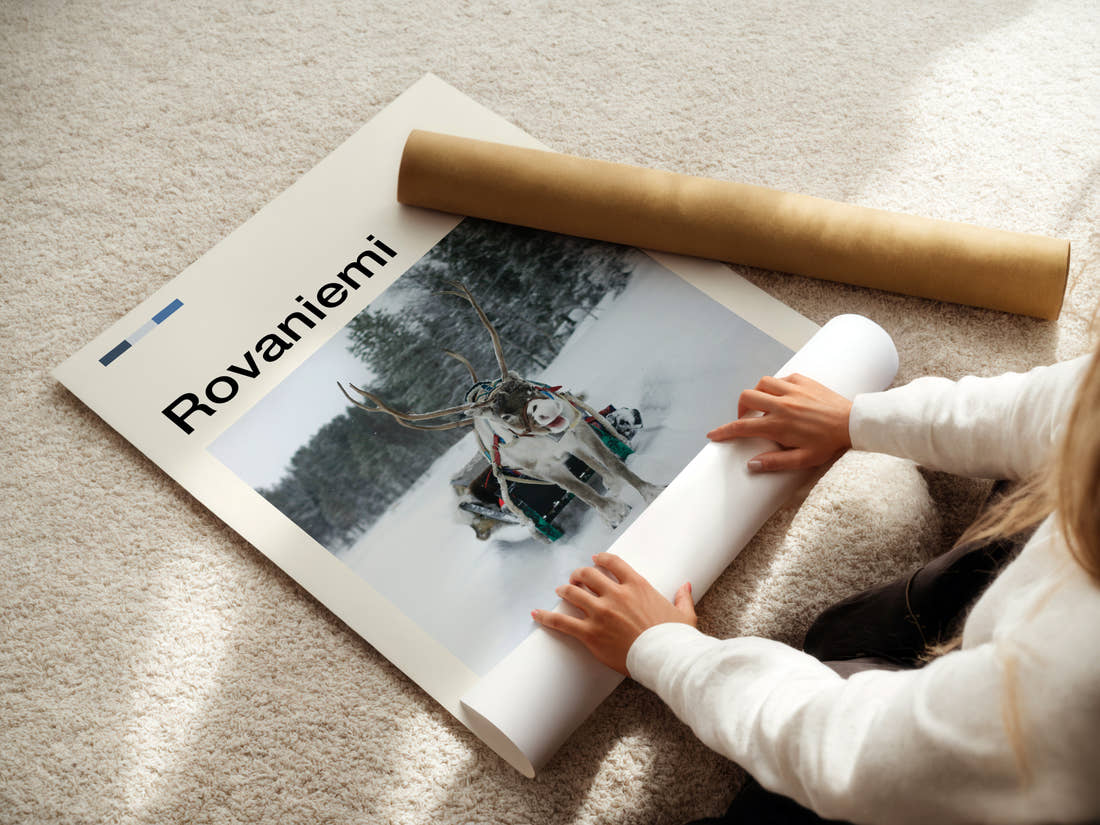 Rovaniemi Reindeer And Sleigh Travel Print being unrolled from its postal tube