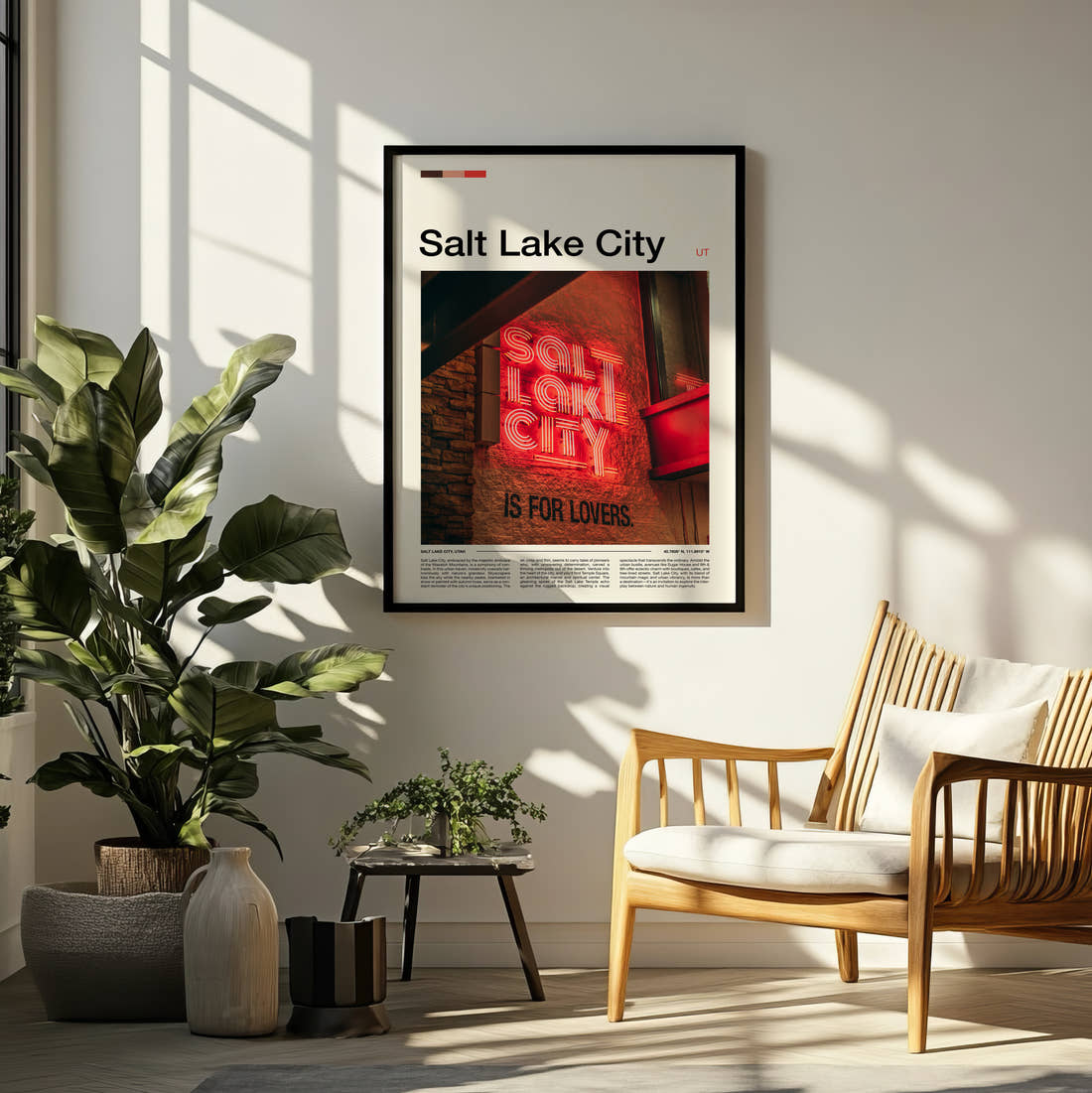 Salt Lake City Neon Sign Travel Print framed on a pale wall beside houseplants