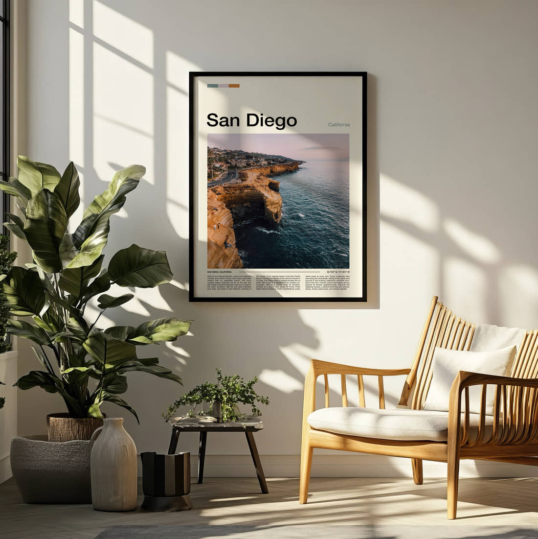 San Diego Coastal Cliffs Travel Print framed on a pale wall beside houseplants