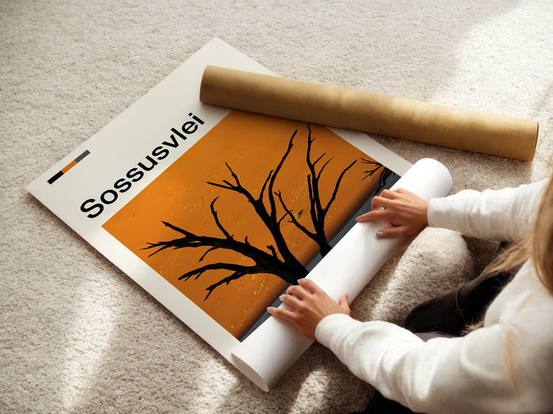 Sossusvlei Dead Tree Silhouette Travel Print being unrolled from its postal tube