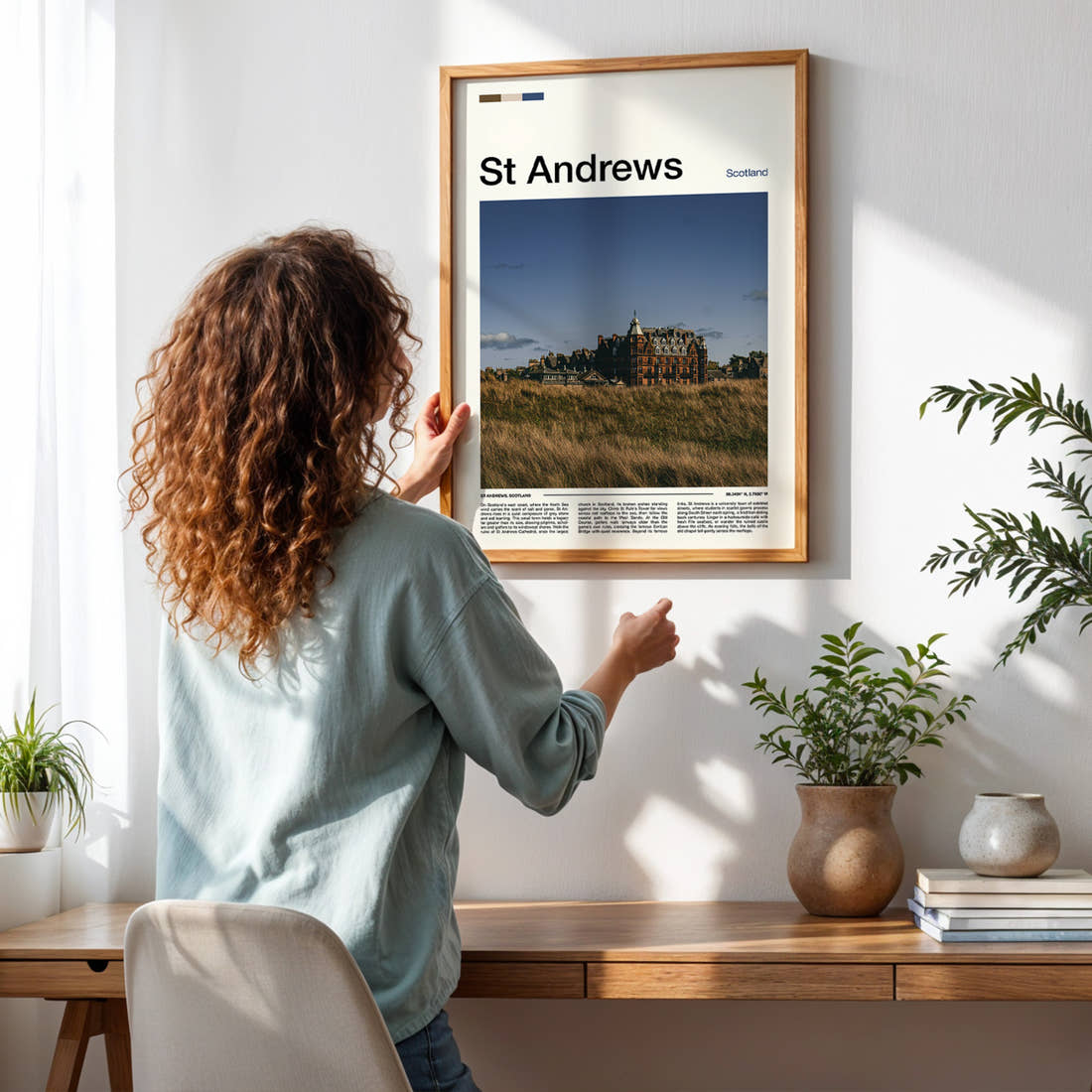 St Andrews Historic Hotel Skyline Travel Print framed on a pale wall beside houseplants